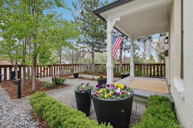 wooden deck with a fenced backyard