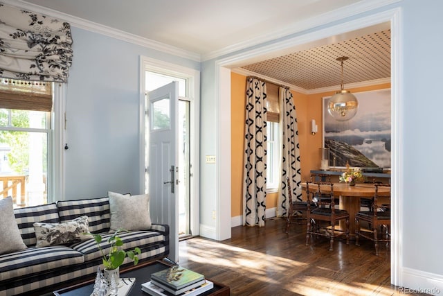 interior space featuring crown molding, baseboards, and wood finished floors