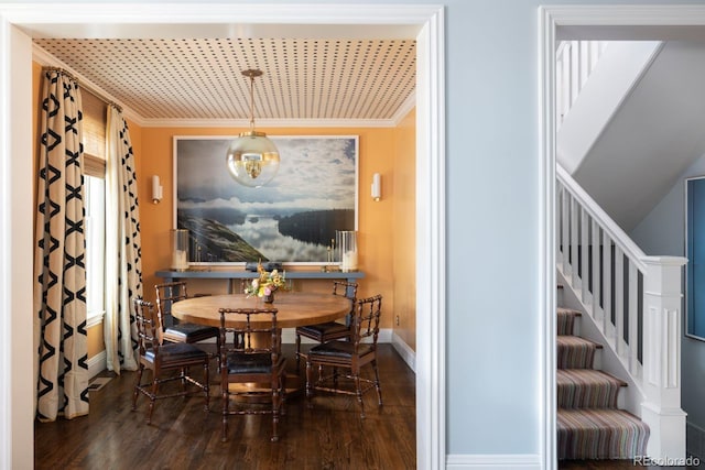 dining space with stairway, wood finished floors, baseboards, and ornamental molding