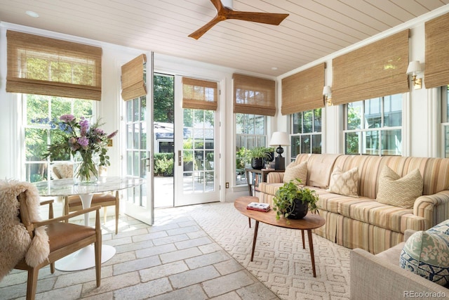 sunroom featuring crown molding, stone tile floors, and wood ceiling