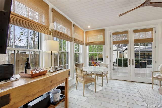 sunroom / solarium featuring recessed lighting, french doors, and stone tile flooring