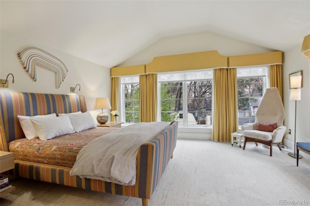 carpeted bedroom with lofted ceiling