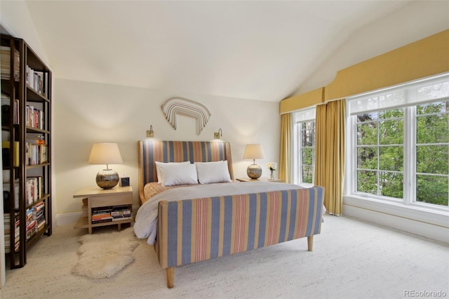 carpeted bedroom featuring vaulted ceiling