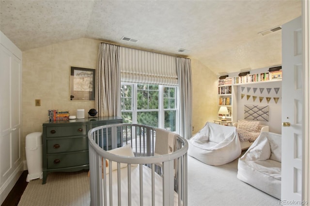 carpeted bedroom featuring visible vents and vaulted ceiling