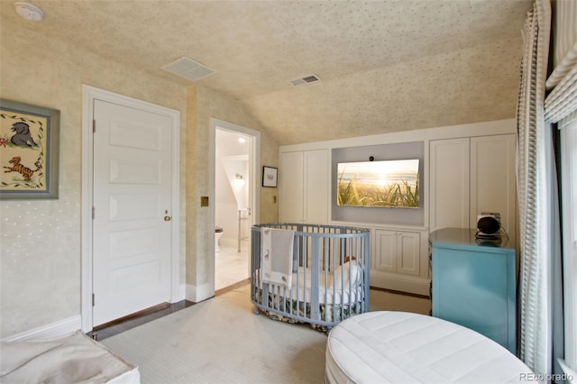 bedroom with visible vents, baseboards, and lofted ceiling