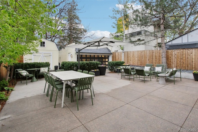 view of patio / terrace with outdoor dining area and fence