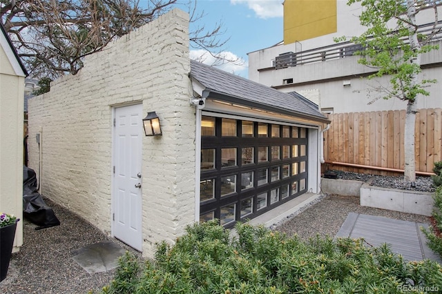 exterior space featuring an outdoor structure and fence