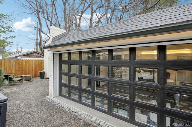details with a shingled roof and fence