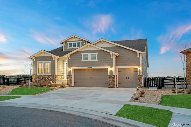 23696 E Del Norte Pl, Aurora, CO 80016 - craftsman house with an attached garage, concrete driveway, stone siding, and roof with shingles