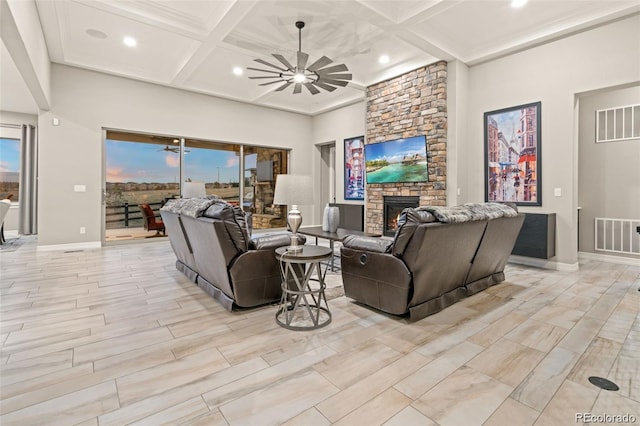 23696 E Del Norte Pl, Aurora, CO 80016 - living area featuring a ceiling fan, coffered ceiling, a stone fireplace, baseboards, and beamed ceiling