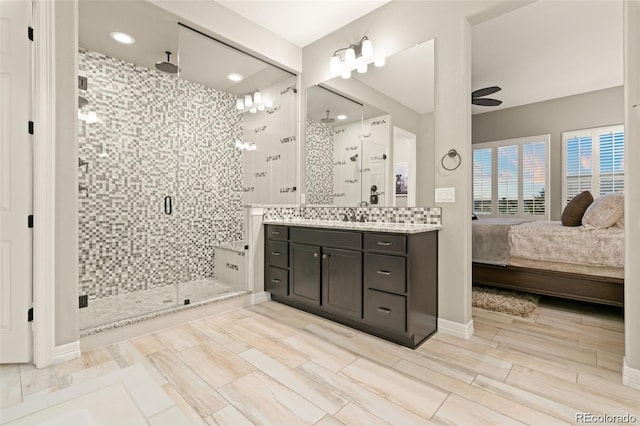 23696 E Del Norte Pl, Aurora, CO 80016 - ensuite bathroom with a shower stall, vanity, a ceiling fan, and baseboards