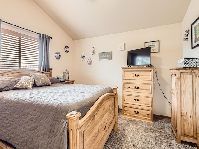 carpeted bedroom featuring baseboards and lofted ceiling