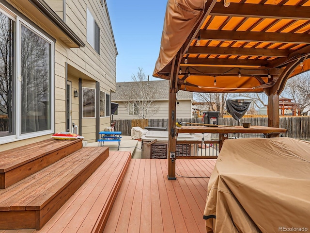 deck featuring a pergola and a fenced backyard