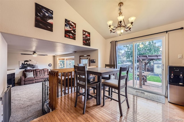 11395 E 116th Dr, Commerce City, CO 80640 - dining room with light wood finished floors, vaulted ceiling, and a chandelier