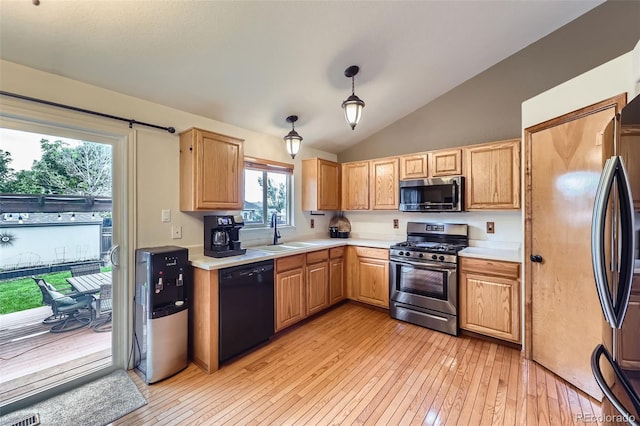 11395 E 116th Dr, Commerce City, CO 80640 - kitchen featuring stainless steel appliances, a sink, light countertops, light wood-type flooring, and vaulted ceiling