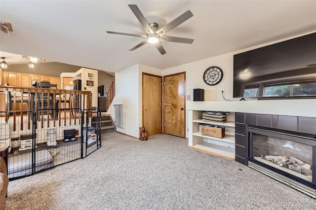 11395 E 116th Dr, Commerce City, CO 80640 - living room with a tile fireplace, a ceiling fan, carpet floors, and stairway