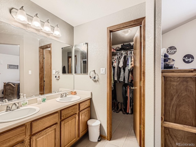 11395 E 116th Dr, Commerce City, CO 80640 - full bathroom featuring double vanity, a walk in closet, and tile patterned flooring