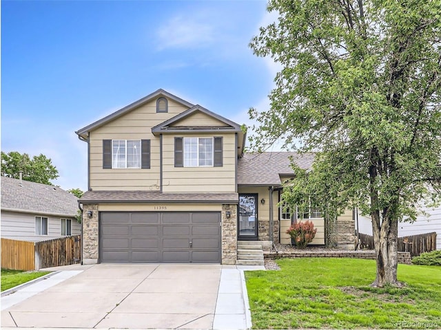11395 E 116th Dr, Commerce City, CO 80640 - view of front of home featuring concrete driveway, a garage, a shingled roof, and stone siding