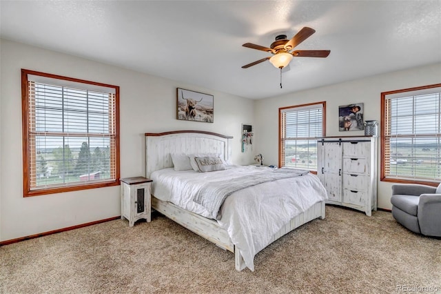 bedroom with carpet floors, baseboards, and a ceiling fan