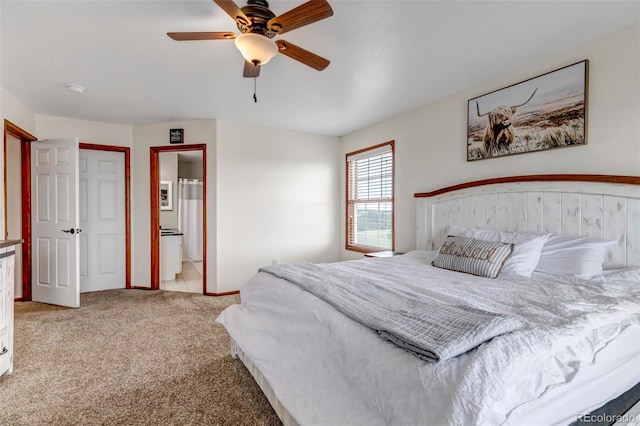 bedroom featuring light carpet, connected bathroom, and a ceiling fan