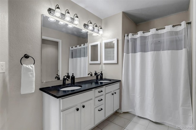 full bath featuring tile patterned floors and double vanity