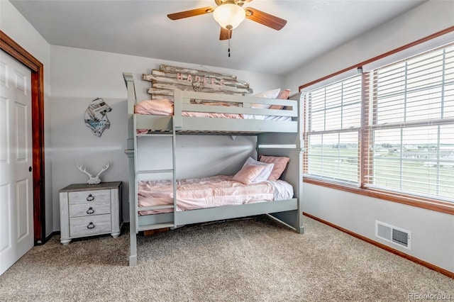 bedroom with carpet, baseboards, a ceiling fan, and a closet