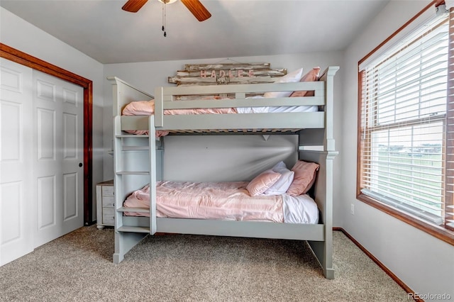 carpeted bedroom featuring a ceiling fan and baseboards
