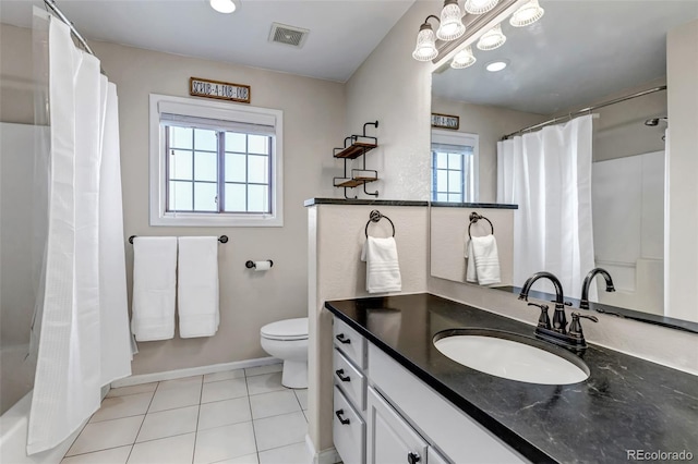 bathroom featuring toilet, vanity, baseboards, and tile patterned floors