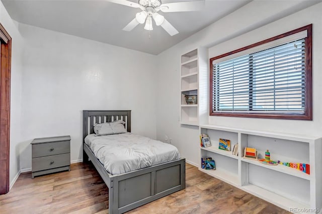 bedroom with wood finished floors and a ceiling fan