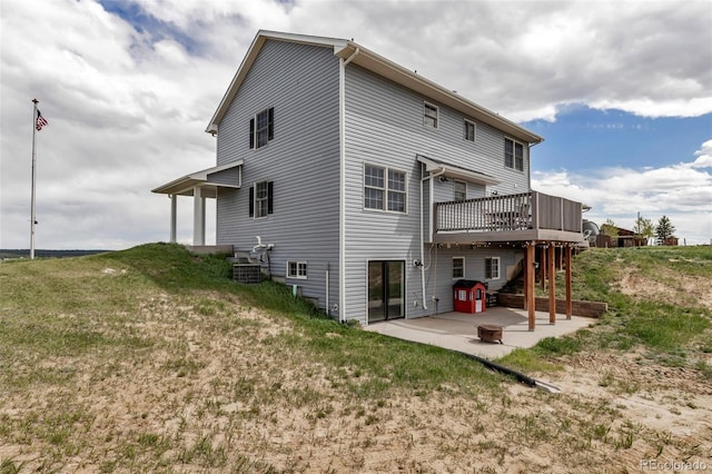 back of property featuring a patio and a wooden deck