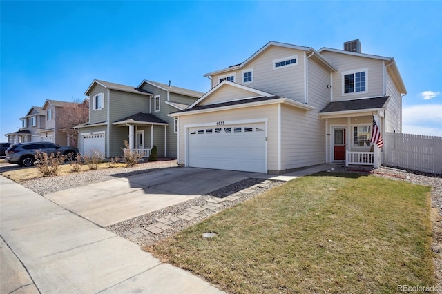 traditional-style home with fence, a front lawn, and concrete driveway