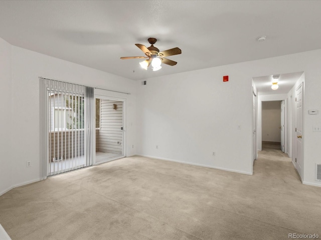 spare room with visible vents, a ceiling fan, and light carpet