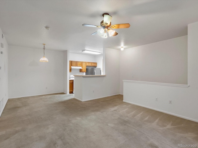 unfurnished living room featuring ceiling fan, light colored carpet, and baseboards