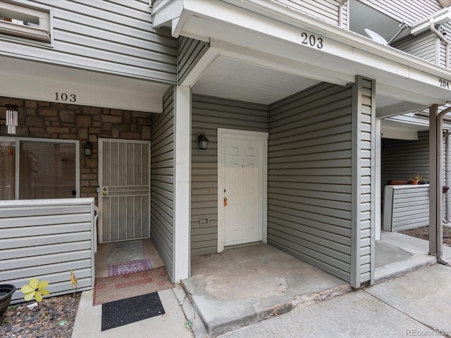 property entrance with stone siding