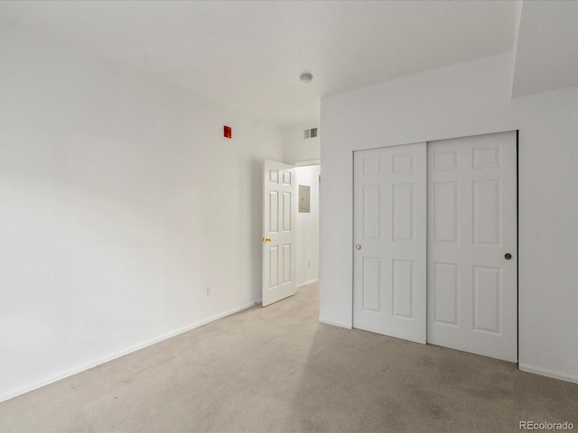 unfurnished bedroom with carpet floors, baseboards, a closet, and visible vents
