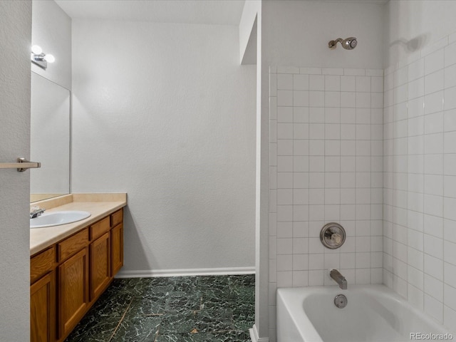 bathroom with vanity, marble finish floor, and washtub / shower combination