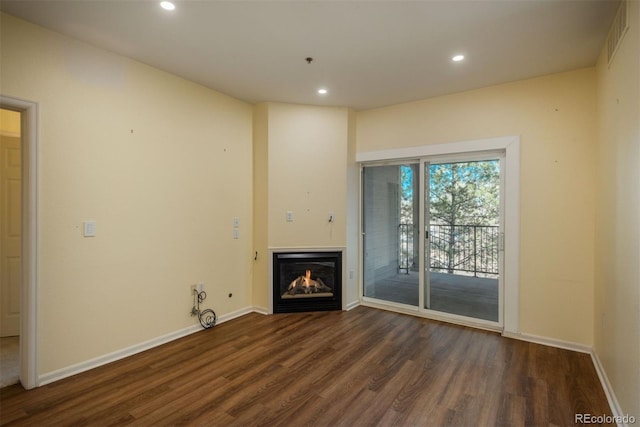 unfurnished living room featuring dark wood-type flooring