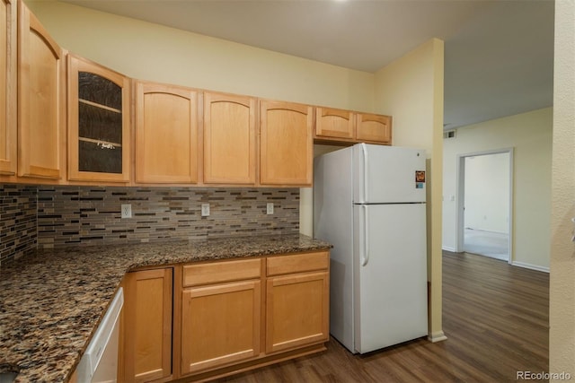 kitchen featuring white appliances, dark wood-style floors, light brown cabinets, glass insert cabinets, and tasteful backsplash