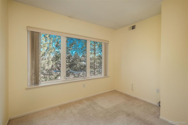 unfurnished room with visible vents, baseboards, and carpet