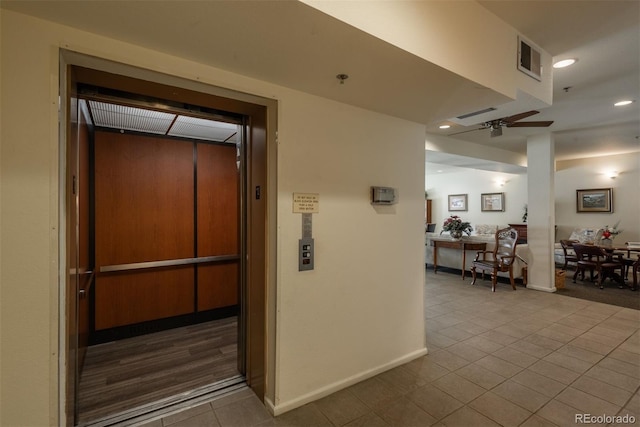 hall featuring tile patterned floors, visible vents, recessed lighting, elevator, and baseboards