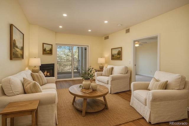 2896 W Riverwalk Cir Unit 204, Littleton, CO 80123 - living room with light wood-style flooring, a lit fireplace, recessed lighting, and a ceiling fan