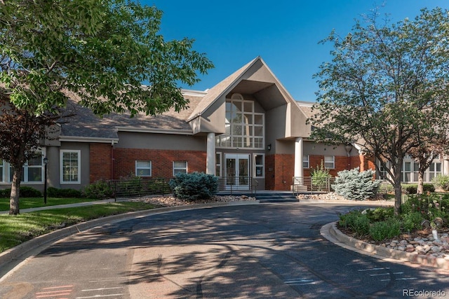 2896 W Riverwalk Cir Unit 204, Littleton, CO 80123 - view of front of property featuring brick siding and curved driveway