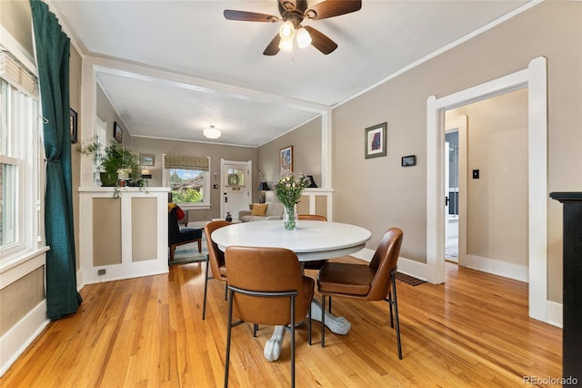 1215 Jackson St, Denver, CO 80206 - dining area with light wood-style floors, ceiling fan, and crown molding