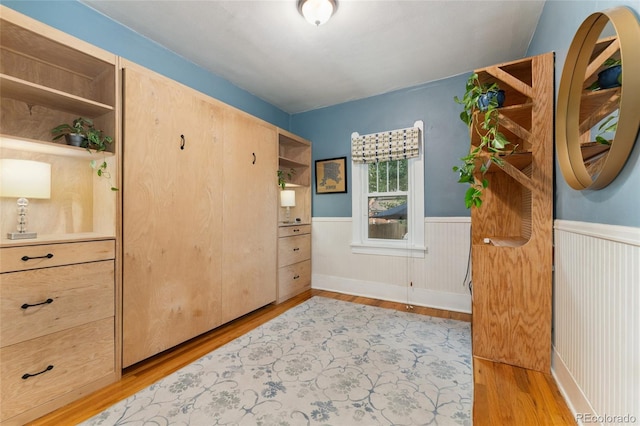 1215 Jackson St, Denver, CO 80206 - bedroom with light wood-type flooring and a wainscoted wall