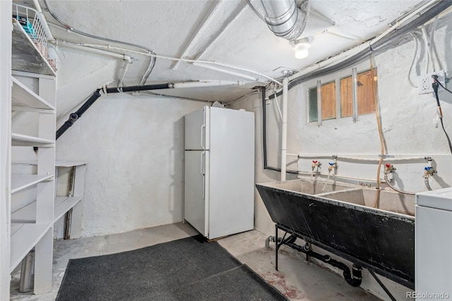 1215 Jackson St, Denver, CO 80206 - basement with freestanding refrigerator and washer / dryer