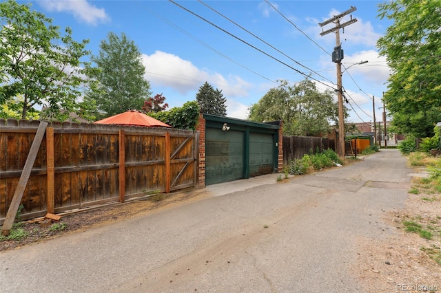 1215 Jackson St, Denver, CO 80206 - view of asphalt road with street lights and a gate