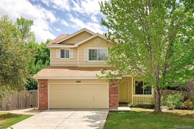 4860 W 125th Ave, Broomfield, CO 80020 - view of front facade featuring brick siding, a garage, driveway, and a shingled roof