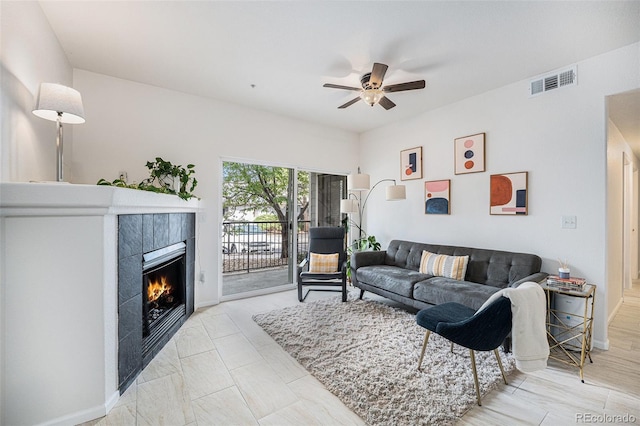 4451 S Ammons St Unit 4-108, Littleton, CO 80123 - living area with a ceiling fan, a fireplace, and baseboards