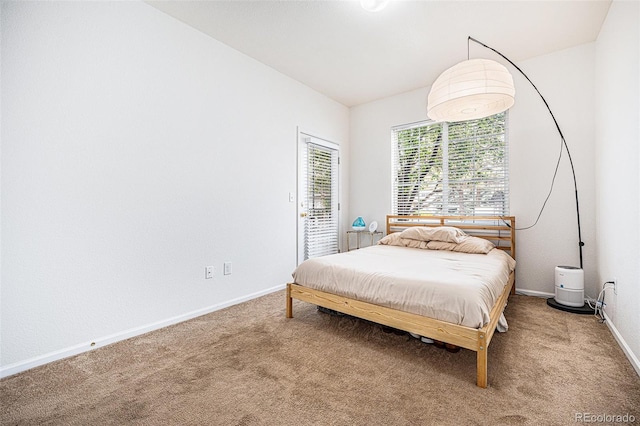 4451 S Ammons St Unit 4-108, Littleton, CO 80123 - carpeted bedroom featuring access to outside and baseboards