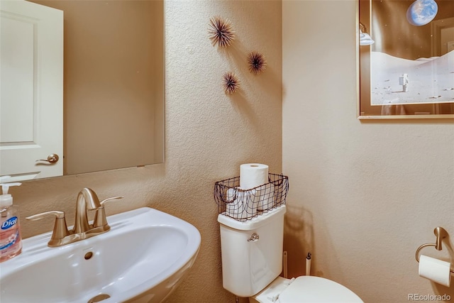 bathroom with toilet and sink